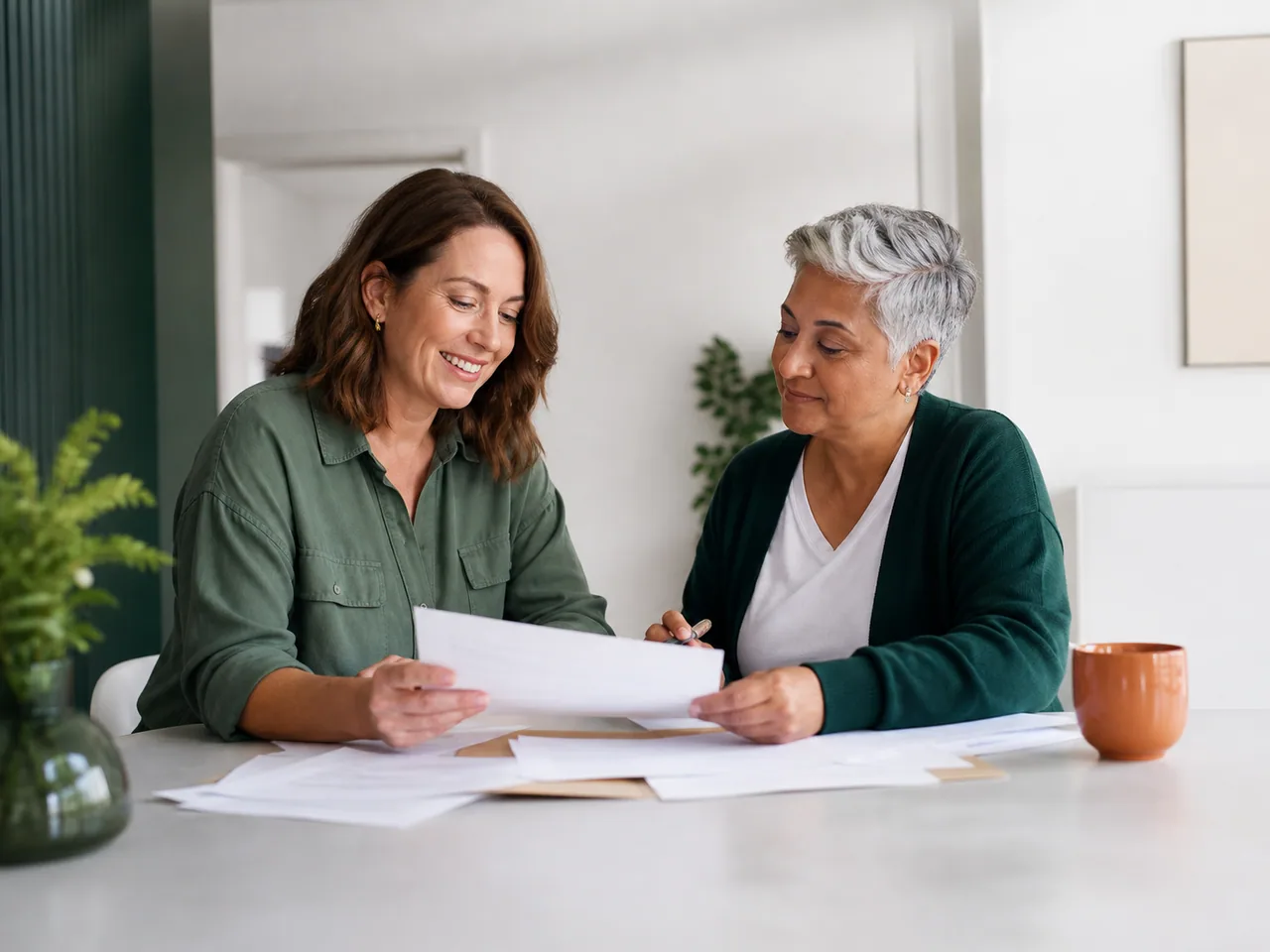 Two adults working together to organise everyday paperwork